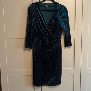 Short green velvet like cocktail dress with detail